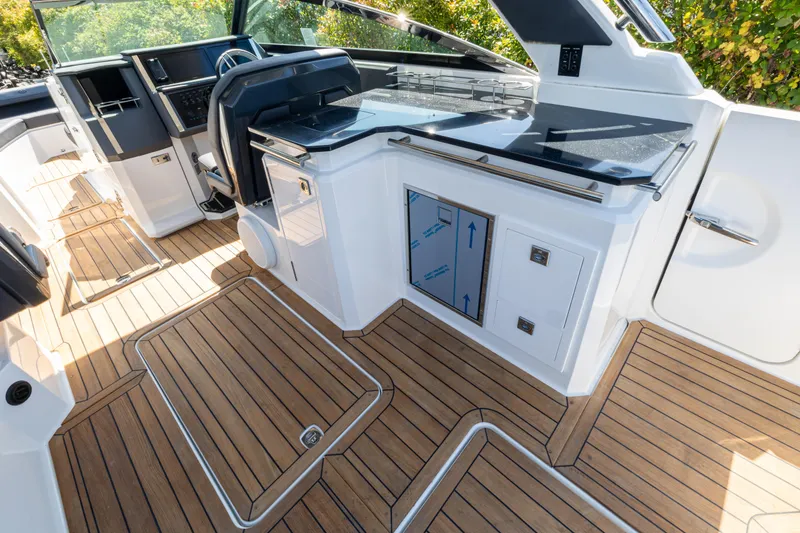 Slide: The Image of 2024 Cobalt R33 boat interior with sleek design and wood flooring. - 11