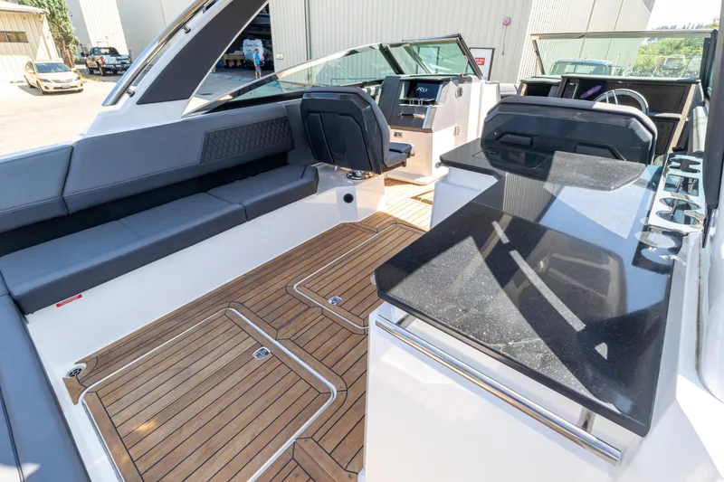 Slide: The Image of 2024 Cobalt R33 boat interior with sleek seating and modern dashboard. - 12