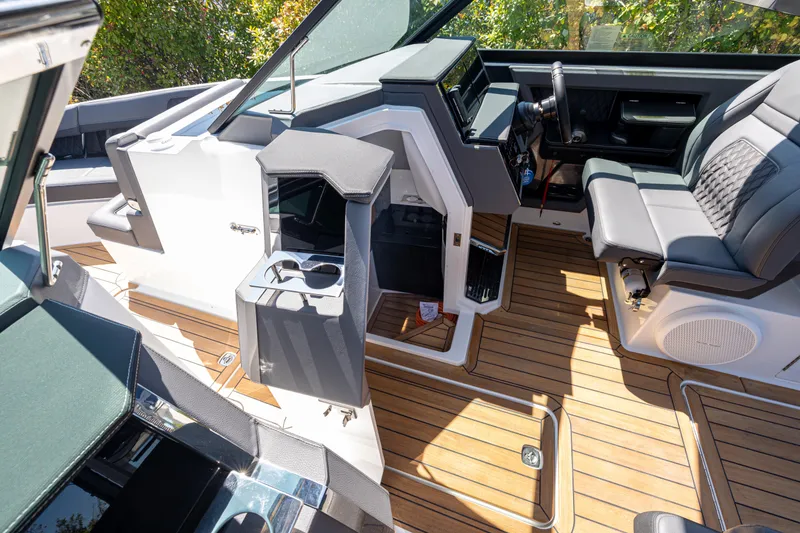 Slide: The Image of 2024 Cobalt R33 boat interior with luxurious seating and wood flooring. - 14