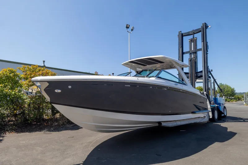 Slide: The Image of 2024 Cobalt R33 boat on trailer under clear blue sky. - 2
