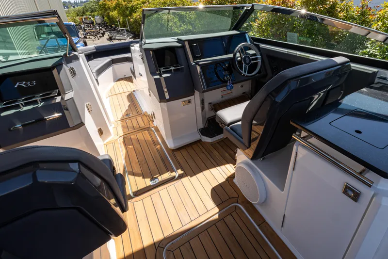 Slide: The Image of Interior of 2024 Cobalt R33 boat with sleek design and wooden flooring. - 5