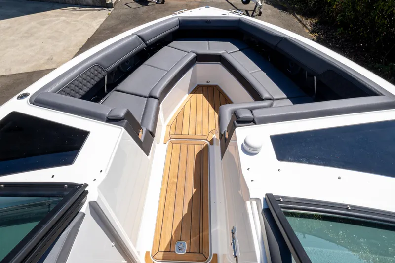 Slide: The Image of 2024 Cobalt R33 boat interior with sleek seating and wooden flooring. - 6