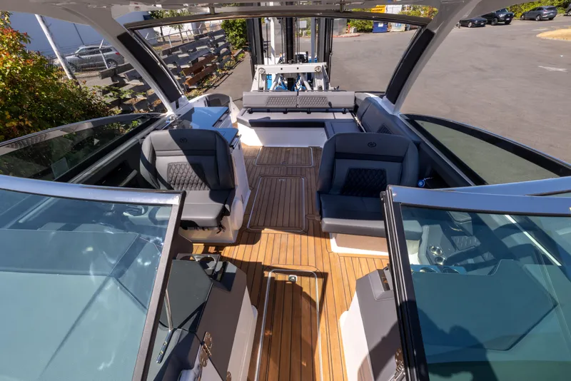 Slide: The Image of 2024 Cobalt R33 boat interior with sleek seating and wooden flooring. - 8
