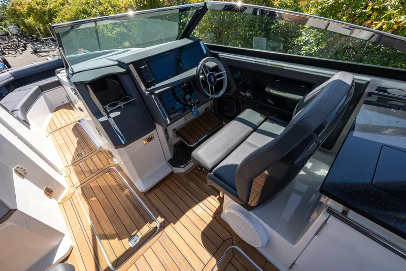 Slide: The Image of 2024 Cobalt R33 boat interior with sleek dashboard and luxurious seating. - 9