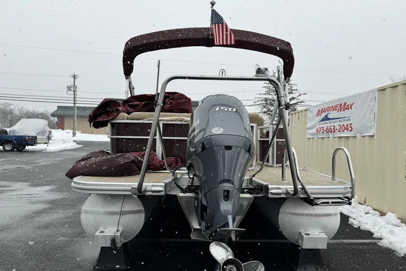 Slide: The Image of 2017 Bennington SX24 pontoon boat with Yamaha 150 engine in snowy parking lot. - 11