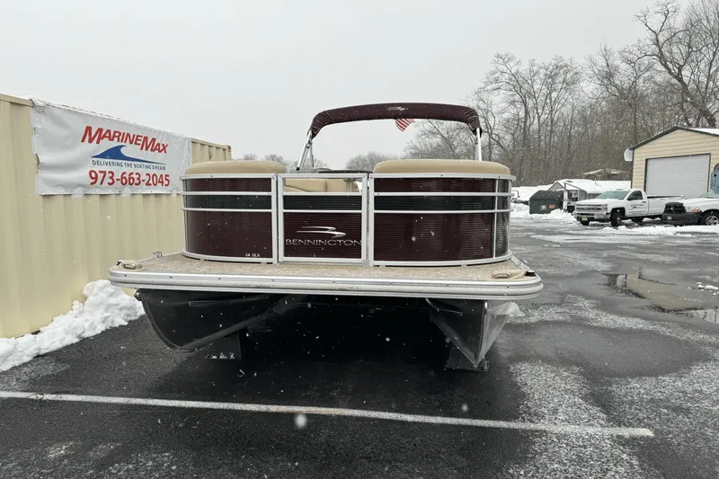 Slide: The Image of 2017 Bennington SX24 pontoon boat in a snowy MarineMax dealership lot. - 34