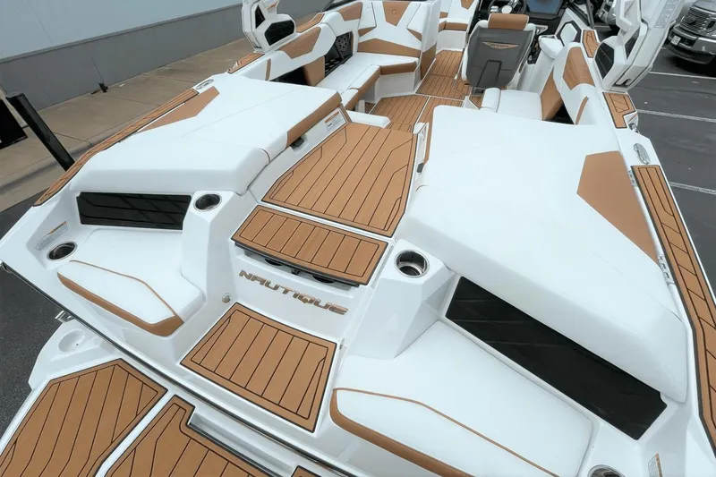 Slide: The Image of 2023 Nautique S21 Super Air boat interior with white and tan seating. - 24