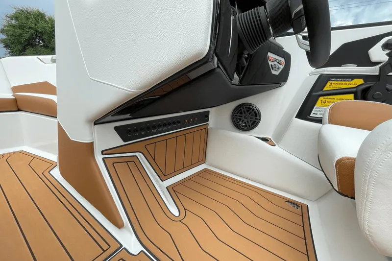 Slide: The Image of 2023 Nautique S21 Super Air boat interior with teak flooring and modern controls. - 43