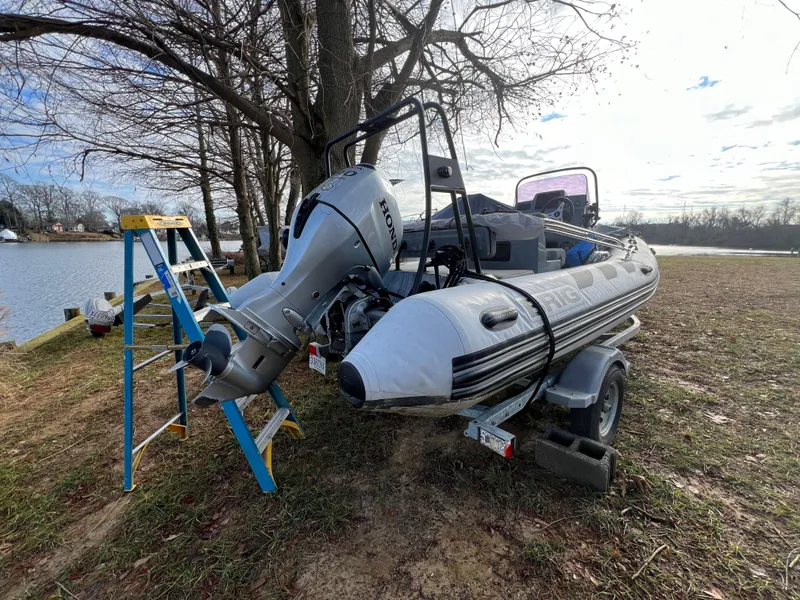 Slide: The Image of 2021 Brig Inflatables Navigator 520 boat on trailer by lakeside with Honda outboard motor. - 15