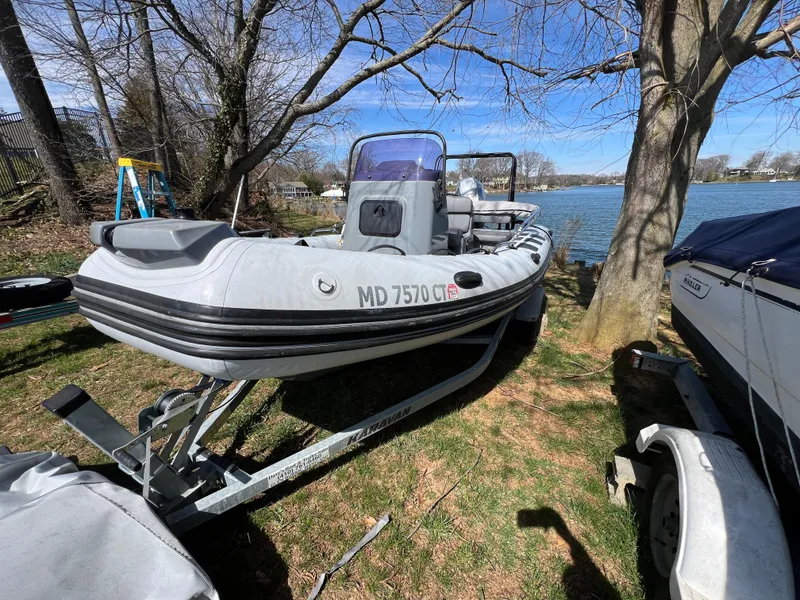 Slide: The Image of 2021 Brig Inflatables Navigator 520 boat on a trailer by a lakeside. - 22