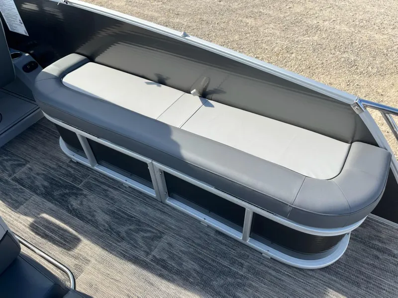 Slide: The Image of 2021 Godfrey Monaco 255SFL boat with gray seating and storage compartments. - 10