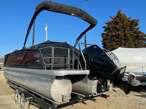 Slide: The Image of 2021 Godfrey Monaco 255SFL pontoon boat on trailer with outboard motor. - 2
