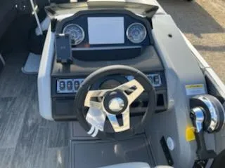 Slide: The Image of 2021 Godfrey Monaco 255SFL boat dashboard with steering wheel and control panel. - 7