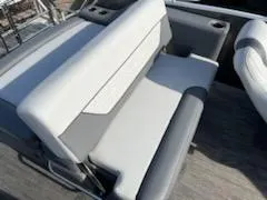 Slide: The Image of 2021 Godfrey Monaco 255SFL boat interior seating with gray and white upholstery. - 8