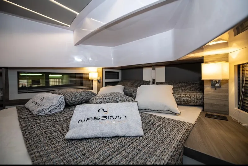 Slide: The Image of Luxurious bedroom interior of Nassima Yacht N40, 2025 model, with elegant bedding and ambient lighting. - 15