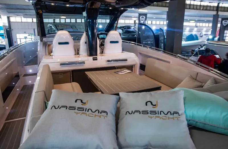 Slide: The Image of Luxurious Nassima Yacht N40 2025 model interior with branded cushions and modern seating. - 18