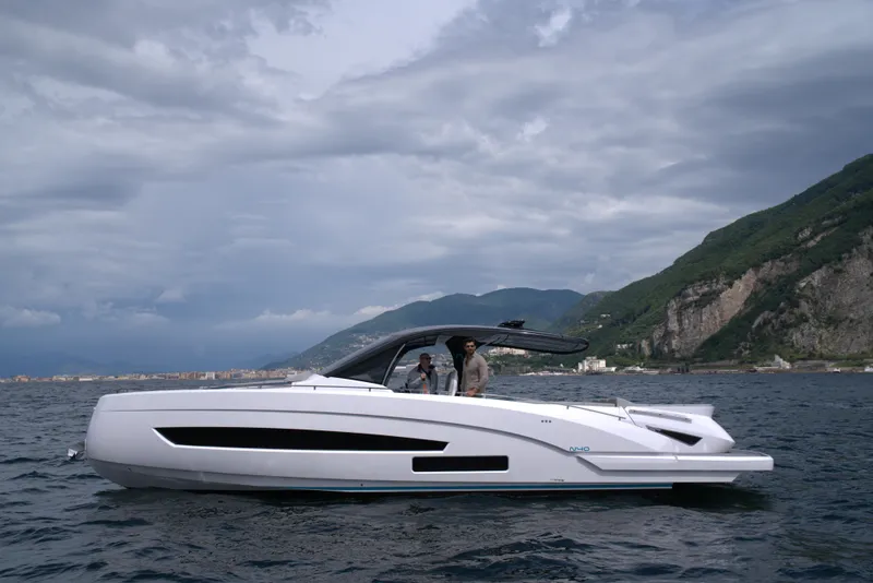 Slide: The Image of Nassima Yacht N40 2025 model cruising on the sea near a mountainous coastline. - 2