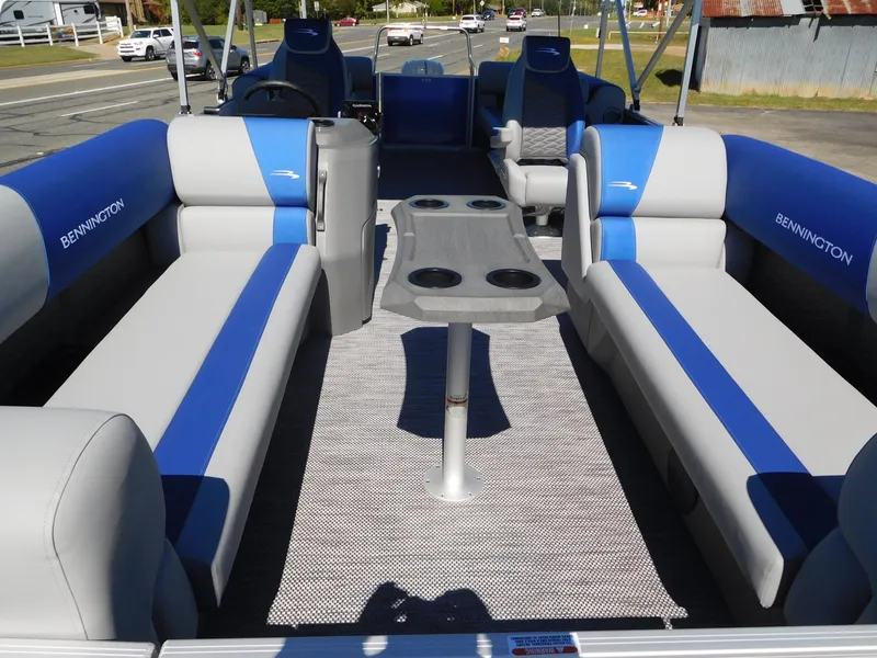 Slide: The Image of 2024 Bennington 22 SSR pontoon boat interior with blue and gray seating. - 2