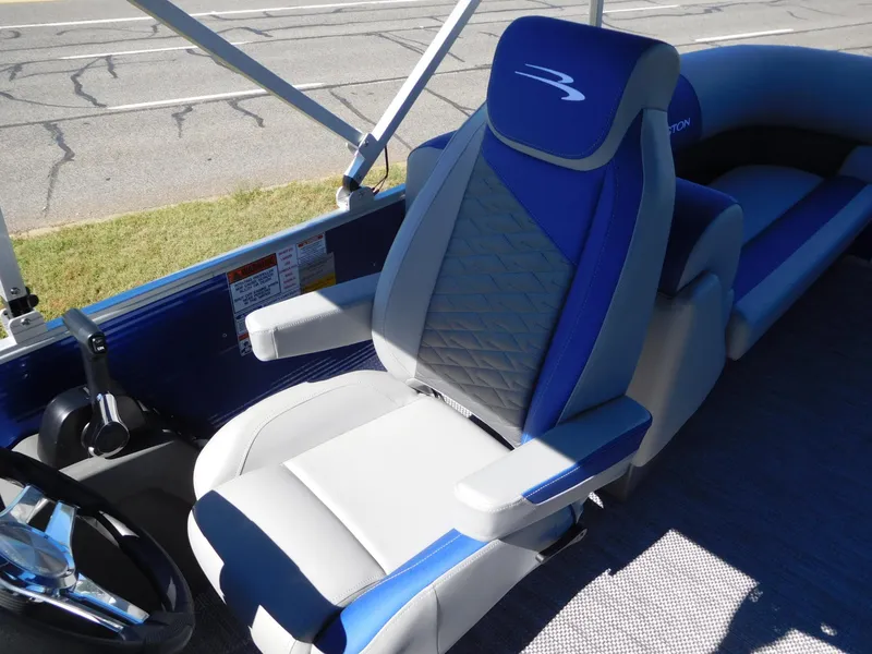 Slide: The Image of 2024 Bennington 22 SSR boat interior with blue and gray captain's chair. - 5