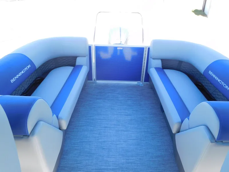 Slide: The Image of 2024 Bennington 22 SSR pontoon boat interior with blue and white seating. - 6