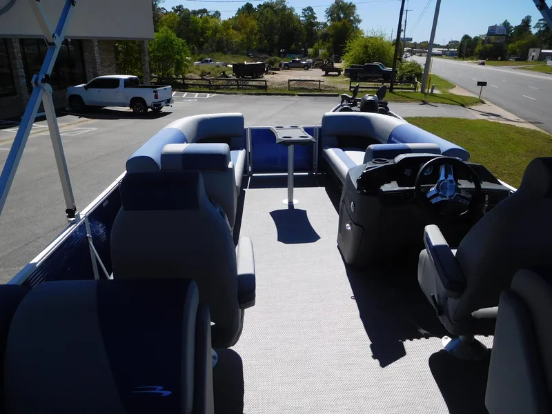 Slide: The Image of 2024 Bennington 22 SSR pontoon boat interior with seating and steering console. - 7