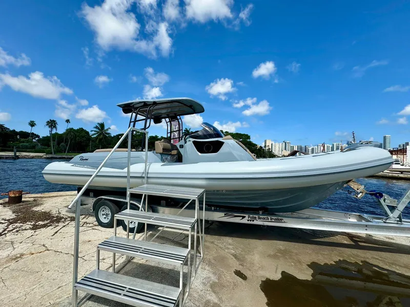 Slide: The Image of 2025 Ranieri CAYMAN 28 EXECUTIVE boat on trailer by waterfront. - 2