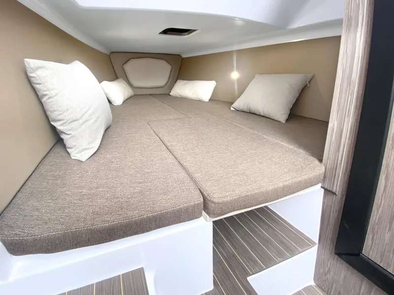 Slide: The Image of 2025 Ranieri CAYMAN 28 EXECUTIVE cabin interior with cushioned bed and pillows. - 25