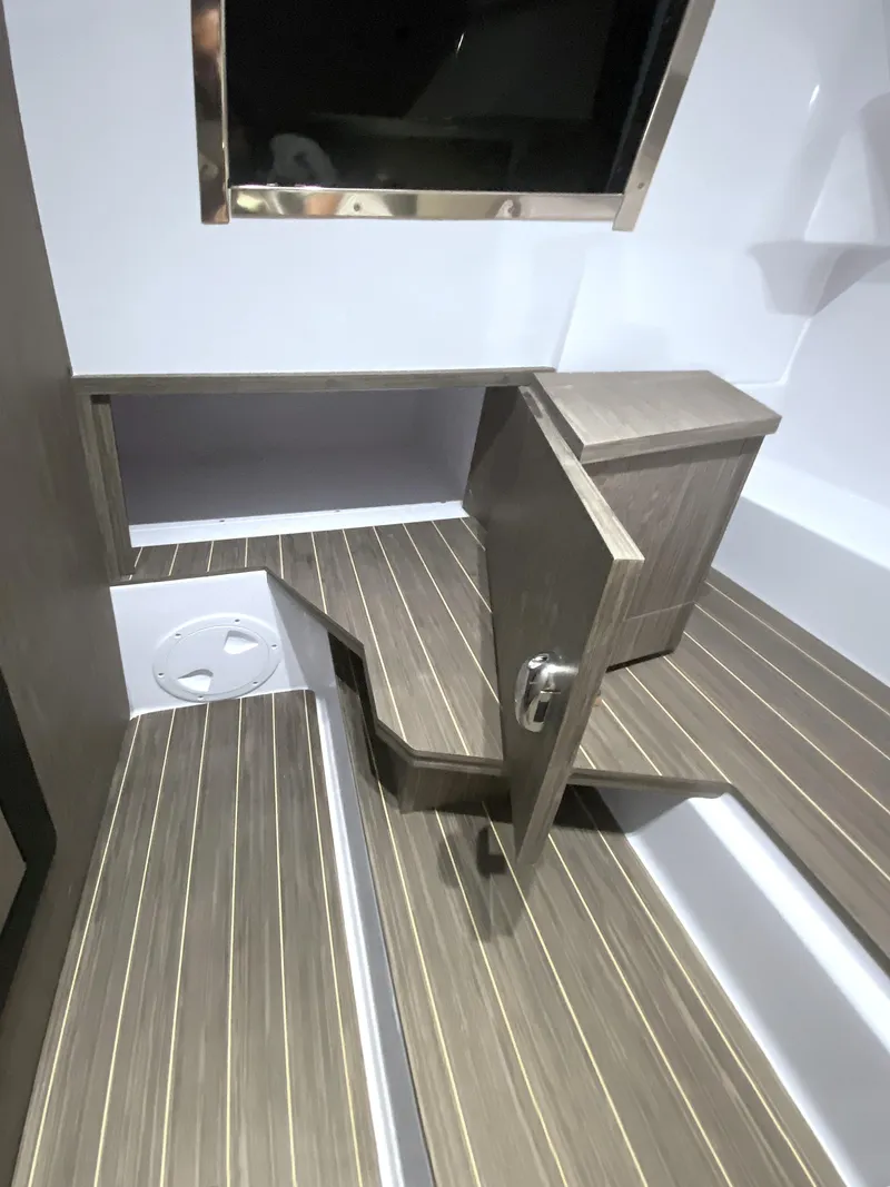 Slide: The Image of Interior of 2025 Ranieri CAYMAN 28 EXECUTIVE with wooden flooring and storage compartment. - 26