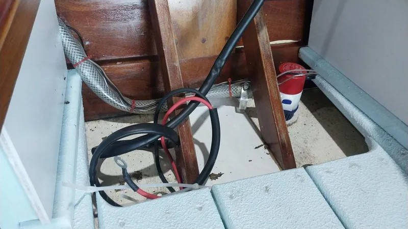 Slide: The Image of Interior of a 2020 Custom 16 Skiff showing wiring and wooden components. - 2