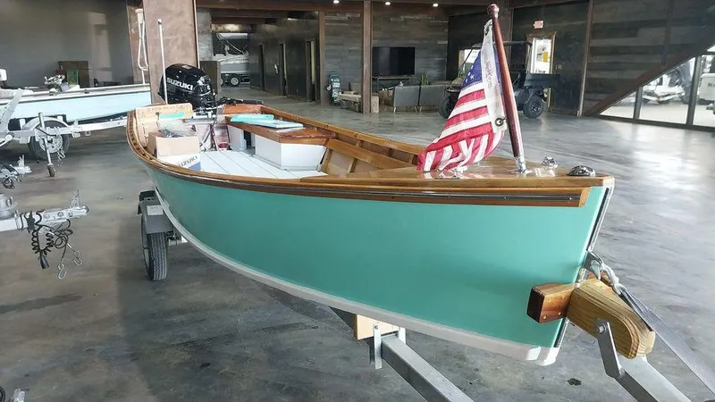 Slide: The Image of Custom 2020 16 Skiff boat with American flag in showroom. - 3