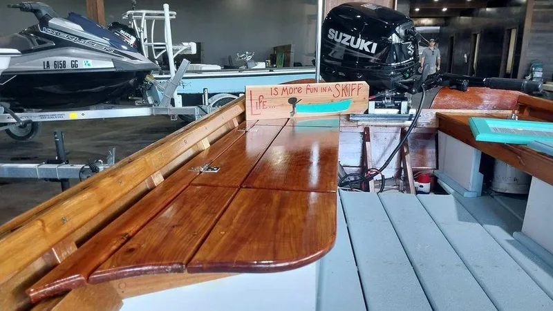 Slide: The Image of Custom 2020 16 Skiff boat with Suzuki outboard motor in a garage. - 5