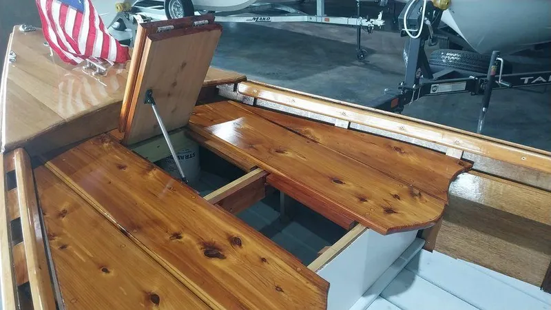 Slide: The Image of Custom 2020 16 Skiff with polished wooden interior and storage compartments. - 7