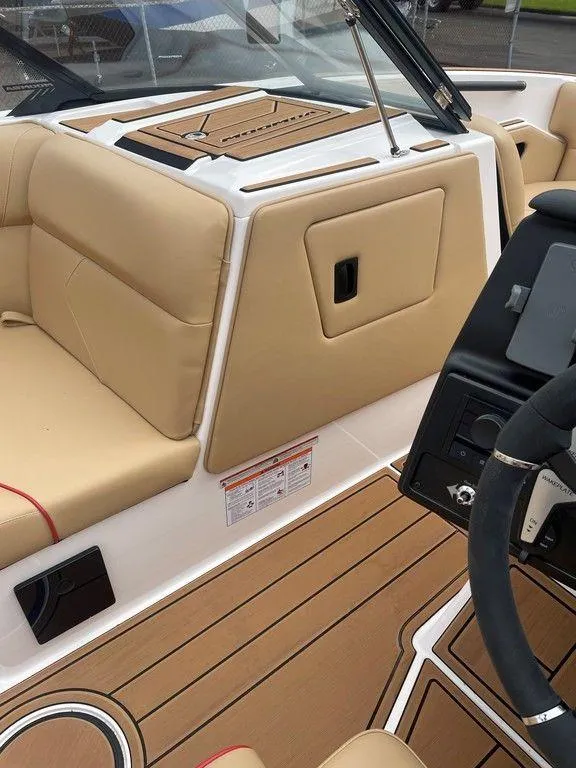 Slide: The Image of 2024 Moomba Tykon boat interior with tan seating and sleek dashboard design. - 14