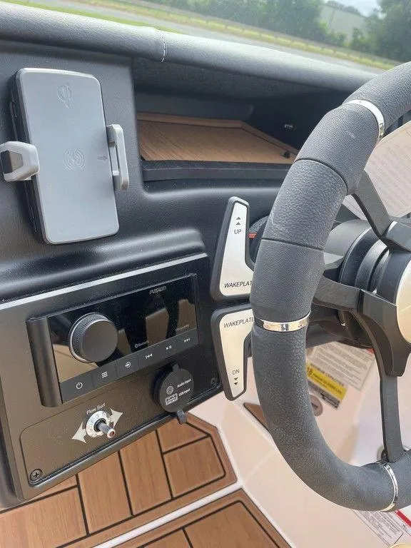 Slide: The Image of 2024 Moomba Tykon dashboard with modern controls and sleek steering wheel design. - 15