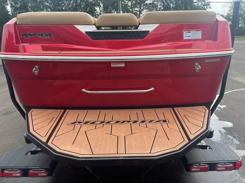 Slide: The Image of 2024 Moomba Tykon boat rear view with Raptor branding and teak swim platform. - 16