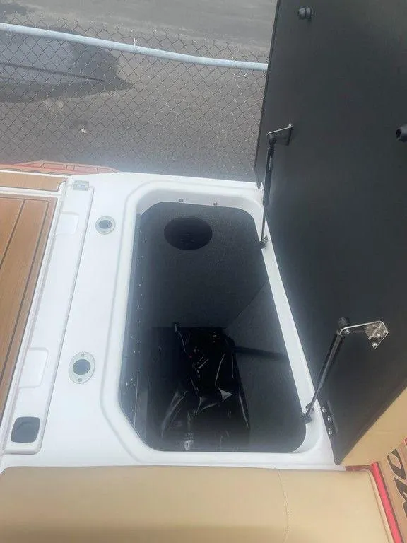 Slide: The Image of 2024 Moomba Tykon boat storage compartment with open lid. - 19