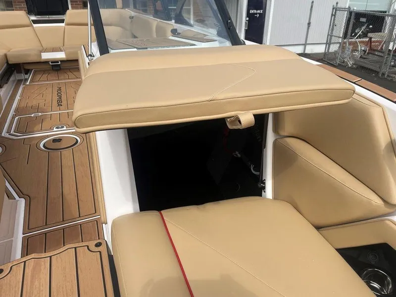 Slide: The Image of 2024 Moomba Tykon boat interior with tan seating and wood flooring. - 23
