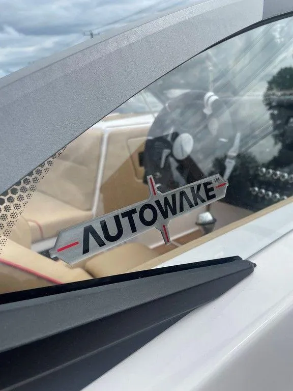 Slide: The Image of 2024 Moomba Tykon boat interior with Autowake feature, showcasing steering wheel and dashboard. - 26