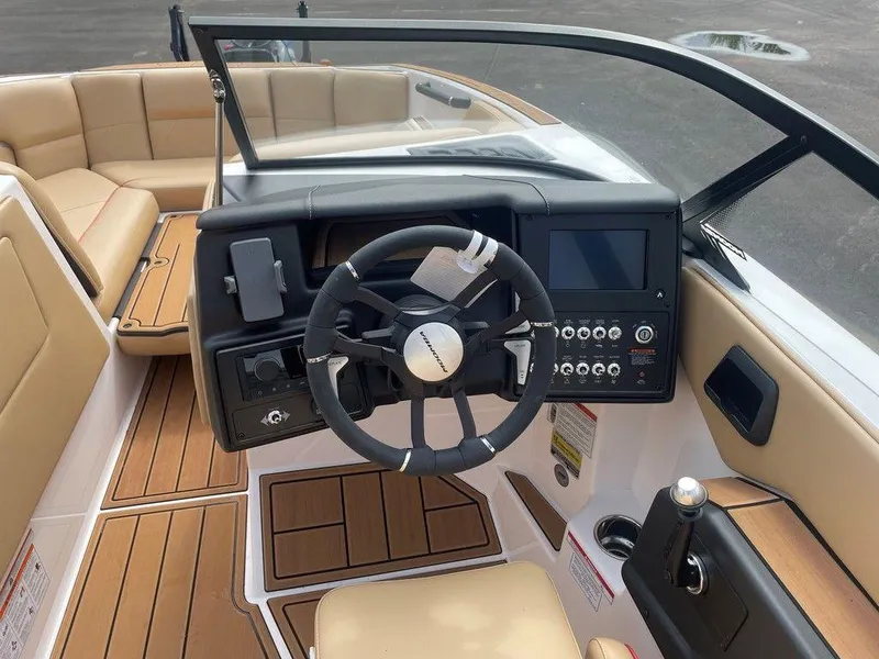 Slide: The Image of 2024 Moomba Tykon boat interior with modern dashboard and tan seating. - 27