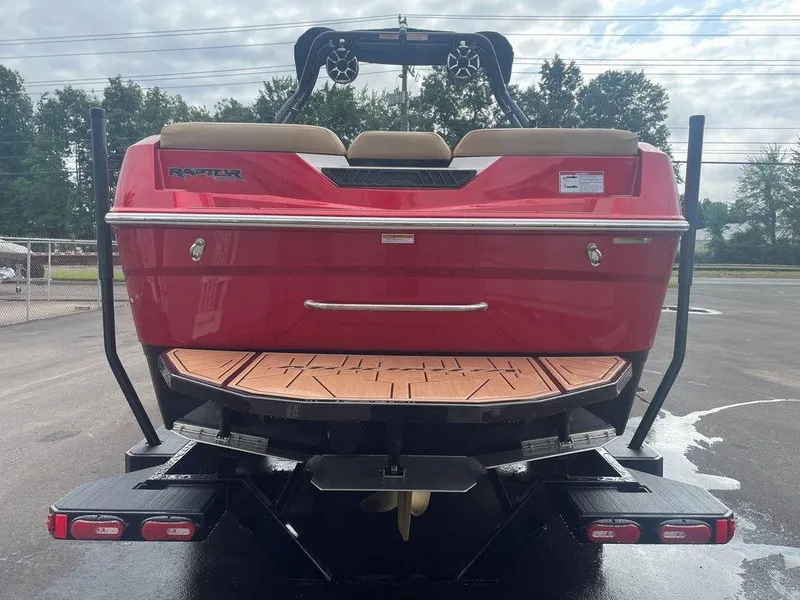 Slide: The Image of 2024 Moomba Tykon boat, red exterior, rear view with swim platform and wakeboard tower. - 35