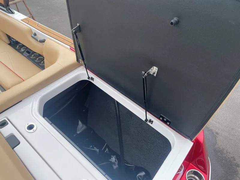 Slide: The Image of 2024 Moomba Tykon boat storage compartment with open lid, showcasing interior space. - 39