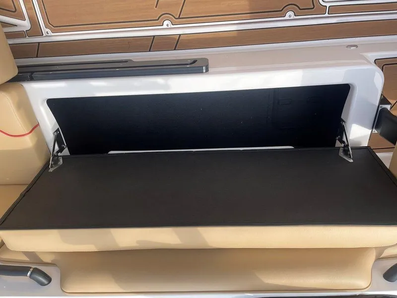 Slide: The Image of 2024 Moomba Tykon boat storage compartment with open lid, showcasing interior space. - 4