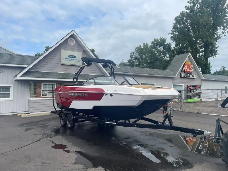 Slide: The Image of 2024 Moomba Tykon boat on trailer outside dealership, overcast day. - 40