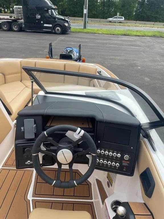 Slide: The Image of 2024 Moomba Tykon boat interior with steering wheel and control panel. - 41