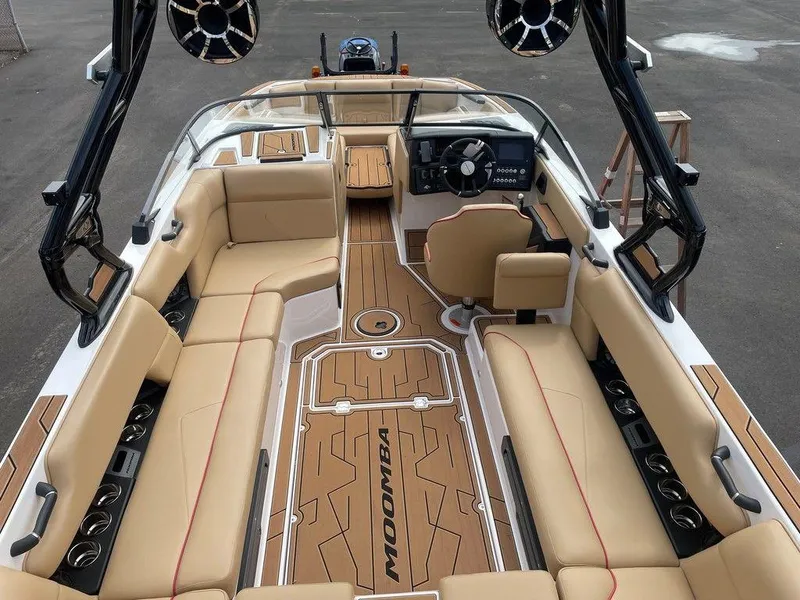 Slide: The Image of 2024 Moomba Tykon boat interior with tan seating and modern dashboard. - 43