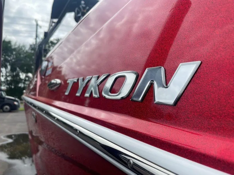 Slide: The Image of 2024 Moomba Tykon boat, red exterior with chrome lettering detail. - 45