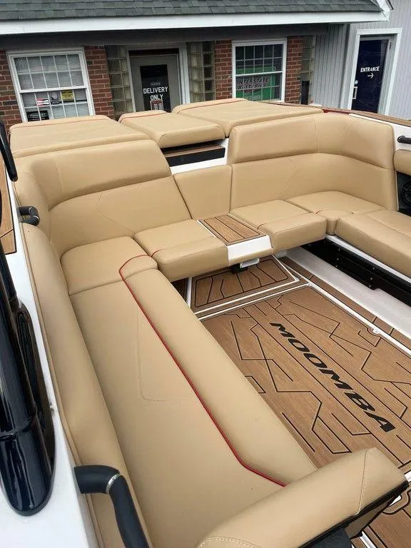 Slide: The Image of 2024 Moomba Tykon boat interior with tan seating and branded flooring. - 47