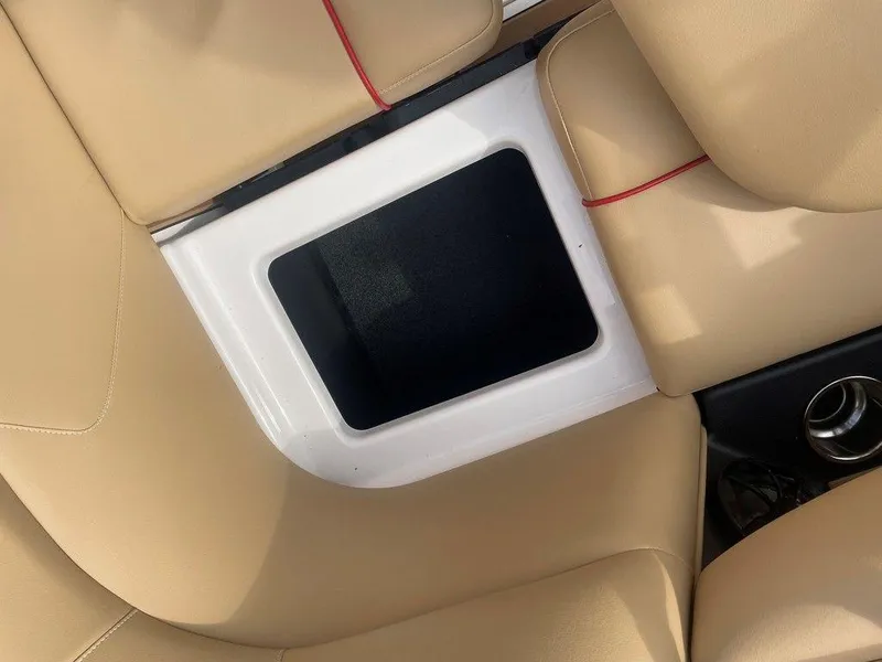 Slide: The Image of 2024 Moomba Tykon boat interior with beige seating and storage compartment. - 6