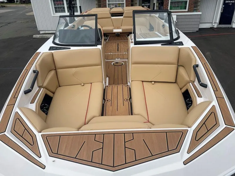 Slide: The Image of 2024 Moomba Tykon boat interior with tan leather seats and wood accents. - 8