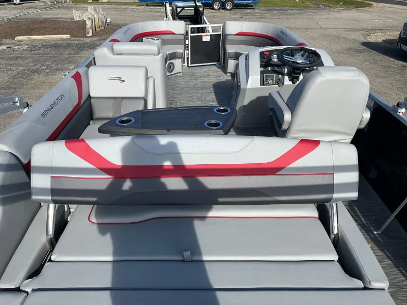 Slide: The Image of 2023 Bennington SX Line pontoon boat interior with gray and red seating. - 10